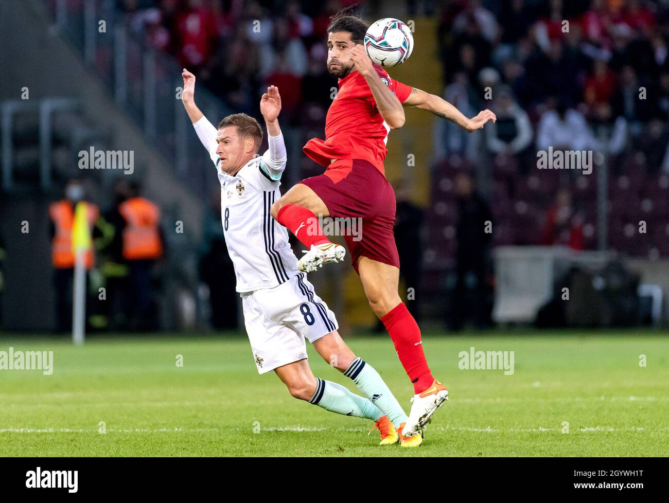 Switzerland's Ricardo Rodriguez (right) and Northern Ireland's Steven Davis battle for the ball during the FIFA World Cup Qualifying match at Stade de Geneve, Switzerland. Picture date: Saturday October 9, 2021. Stock Photo