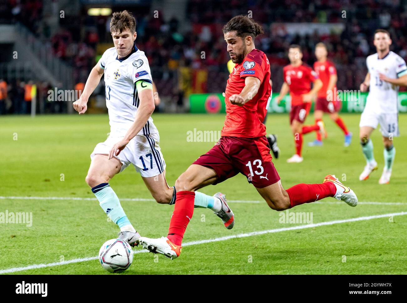 Switzerland's Ricardo Rodriguez (right) and Northern Ireland's Paddy McNair battle for the ball during the FIFA World Cup Qualifying match at Stade de Geneve, Switzerland. Picture date: Saturday October 9, 2021. Stock Photo