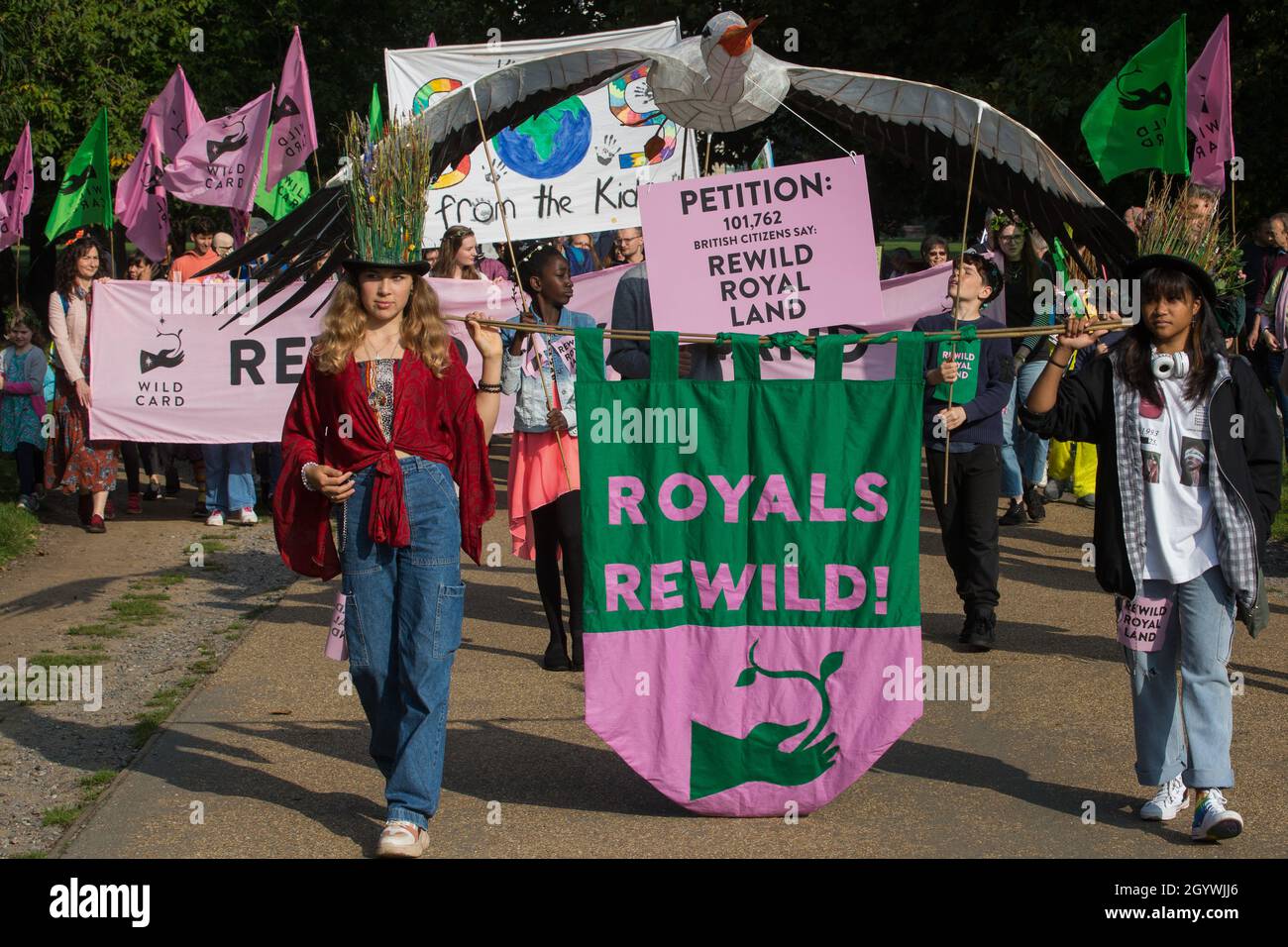 London, UK. 9th October, 2021. Climate activists, including many families, take part in a Rewild Royal Land procession to Buckingham Palace organised by Wild Card, a new campaign calling on the UK’s biggest landowners to rewild, together with 38 Degrees. Campaigners including conservationist and broadcaster Chris Packham are calling on the Royal Family, the largest landowning family in the UK, to rewild their estates in order to assist with tackling the climate crisis and a 14-year-old boy presented a petition at the gates of Buckingham Palace signed by over 100,000 people. Credit: Mark Kerris Stock Photo