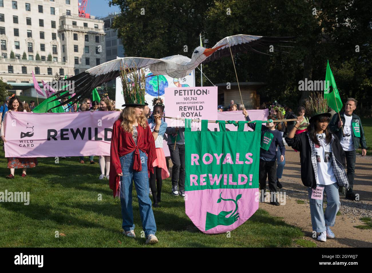 London, UK. 9th October, 2021. Climate activists, including many families, take part in a Rewild Royal Land procession to Buckingham Palace organised by Wild Card, a new campaign calling on the UK’s biggest landowners to rewild, together with 38 Degrees. Campaigners including conservationist and broadcaster Chris Packham are calling on the Royal Family, the largest landowning family in the UK, to rewild their estates in order to assist with tackling the climate crisis and a 14-year-old boy presented a petition at the gates of Buckingham Palace signed by over 100,000 people. Credit: Mark Kerris Stock Photo
