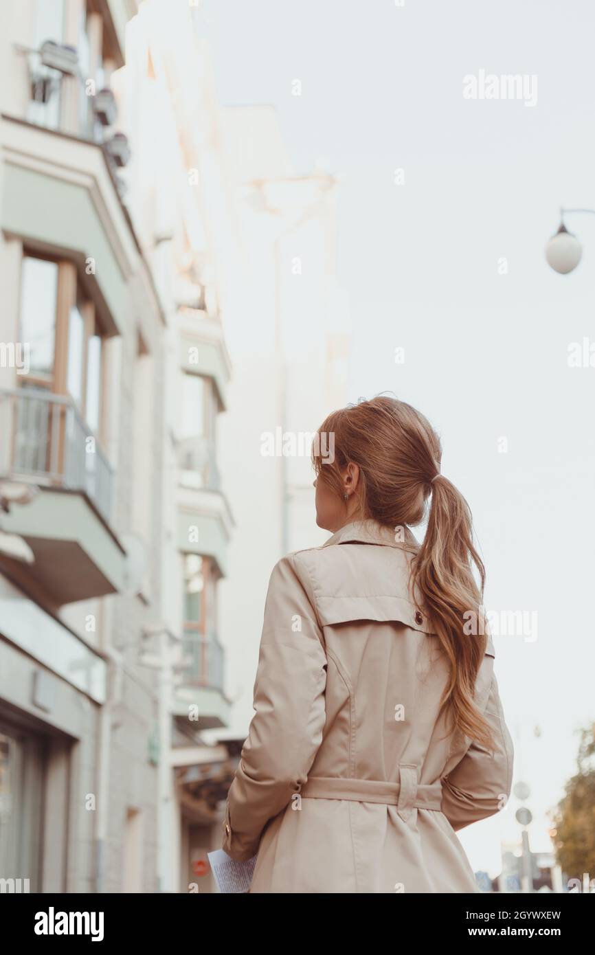 Woman standing coat rear view hi-res stock photography and images - Alamy