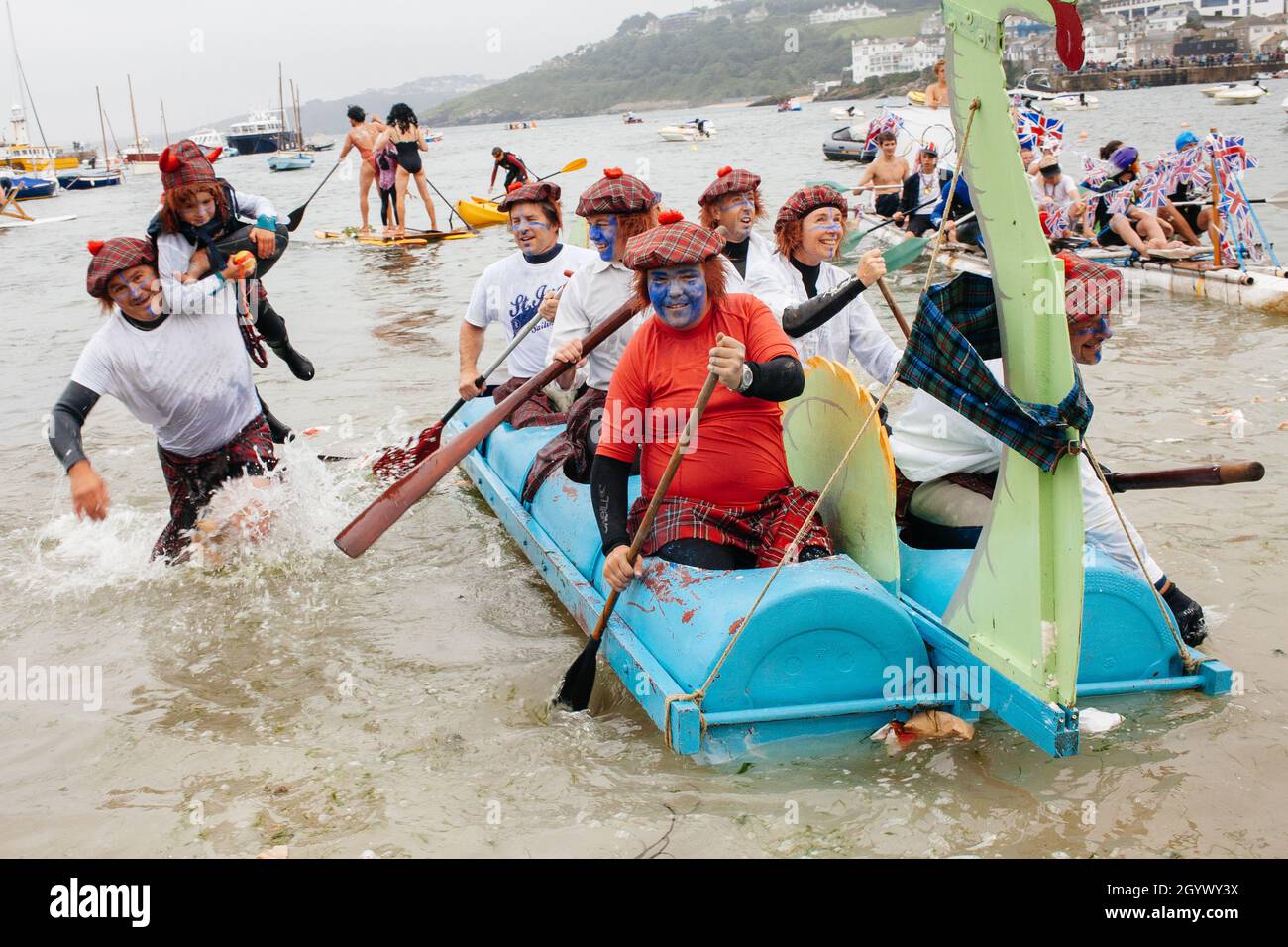 Annual St Ives raft race which takes place in the harbour with spectators throwing flour bombs at participants as they paddle around the course. Stock Photo