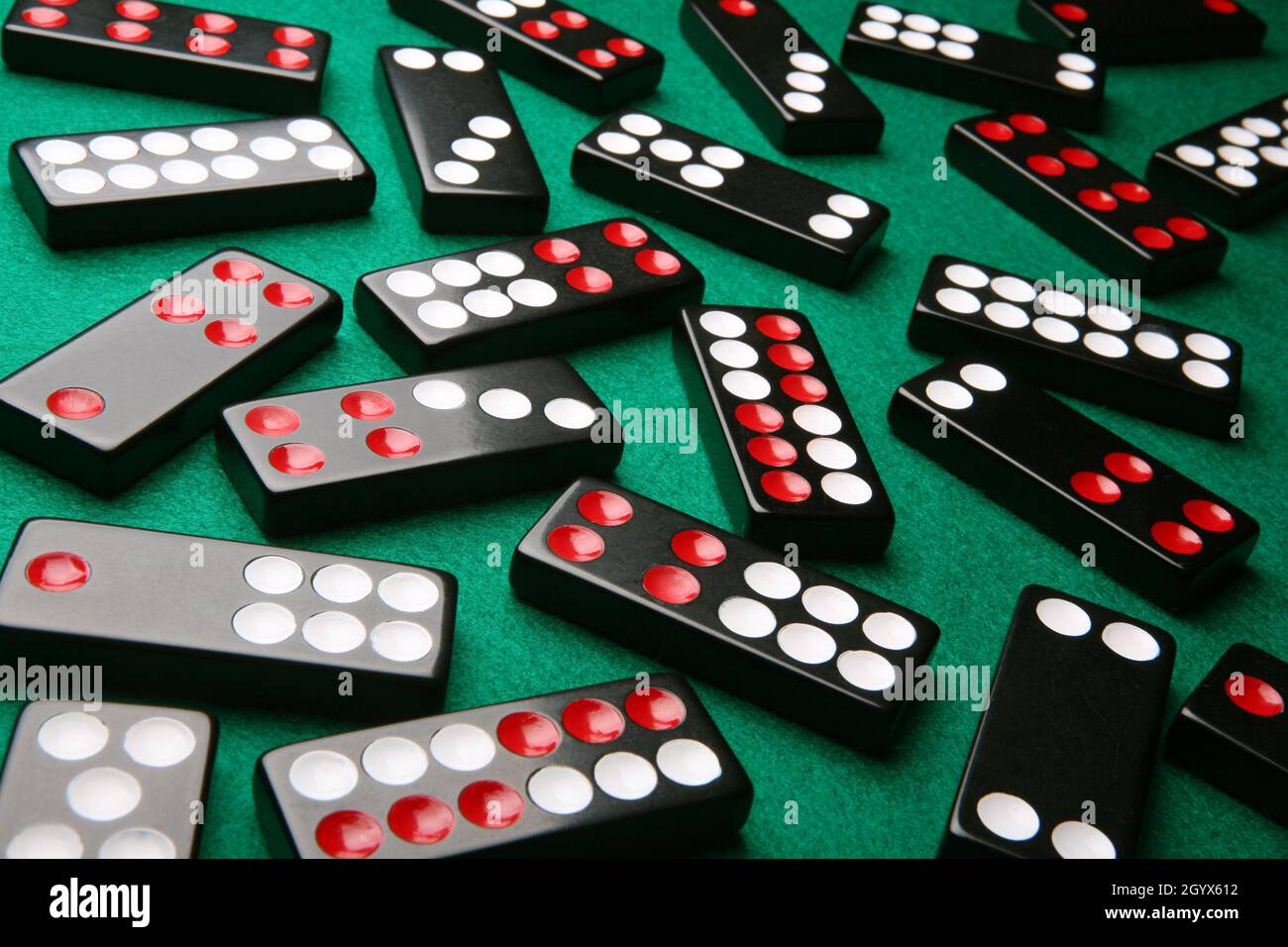 Random assortment of Pai Gow tiles on green felt Stock Photo - Alamy