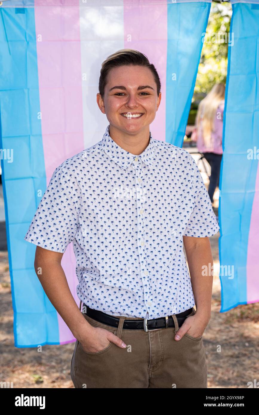 Lauren Pulido, the new Co-Executive Director of the Gender Health Center, stands in front of a transgender flag at a National Trans Visibility March. Stock Photo