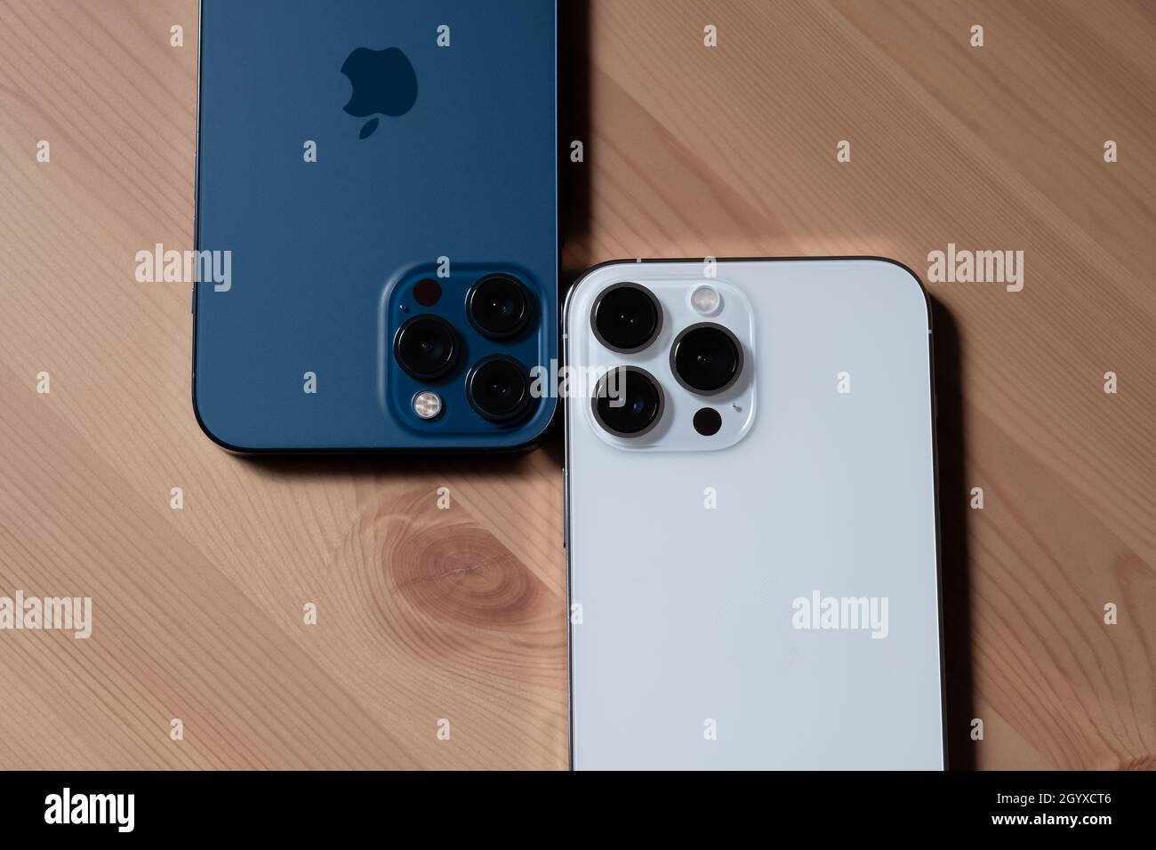 Iphone 13 Pro Max In Silver And Iphone 12 Pro Max In Pacific Blue Stock Photo Alamy