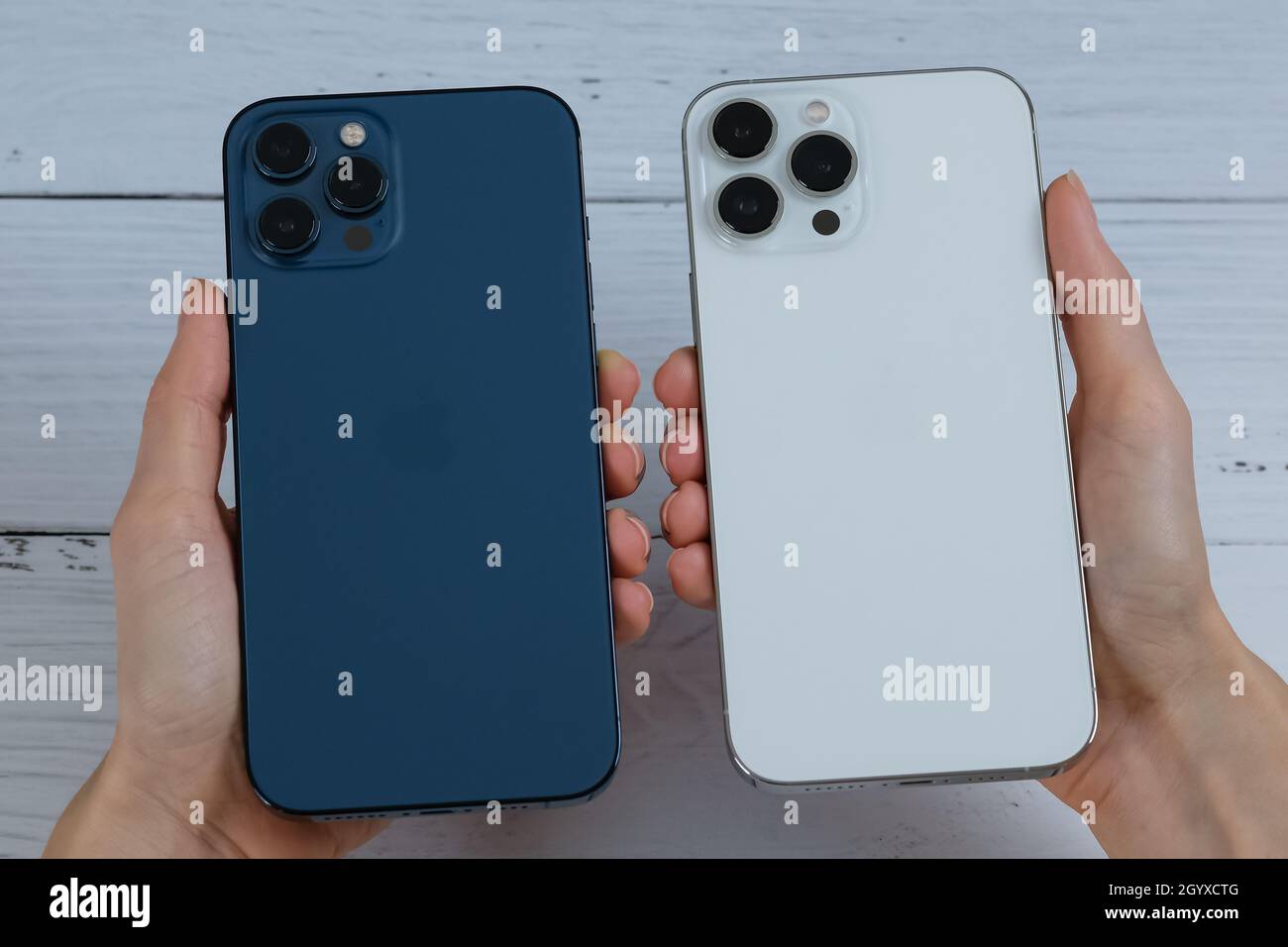 Iphone 13 Pro Max In Silver And Iphone 12 Pro Max In Pacific Blue Stock Photo Alamy