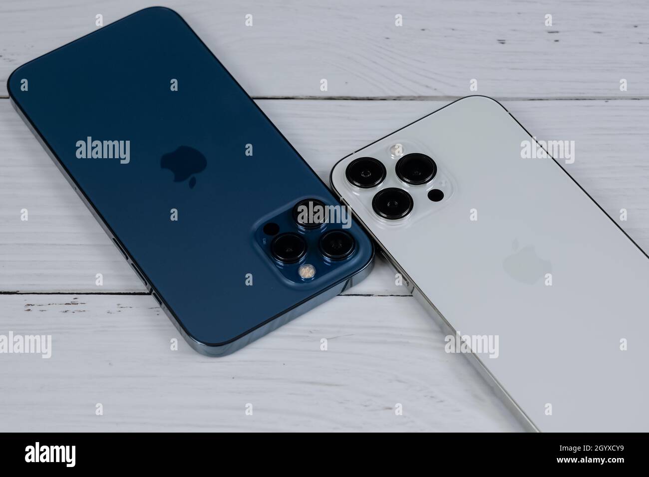 Iphone 13 Pro Max In Silver And Iphone 12 Pro Max In Pacific Blue Stock Photo Alamy