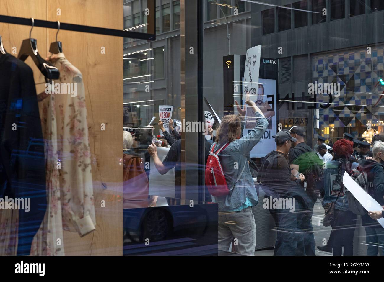 NEW YORK, NY - OCTOBER 9: Animal rights activists protest with signs and  banners in front of the Moncler store on Madison Avenue on October 9, 2021  in New York City. Animal