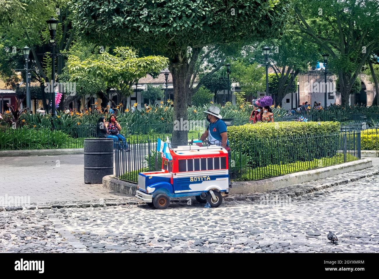 Toy bus at the Plaza Mayor (Parque Central) Antigua, Guatemala, Stock Photo