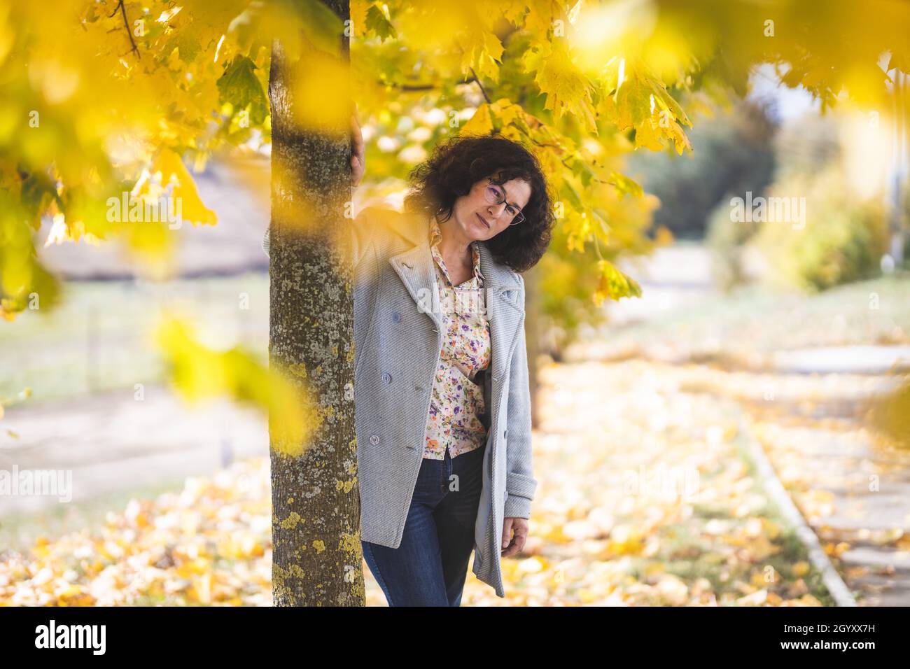 Portrait of beautiful mature woman of fifty years old in autumn park Stock Photo