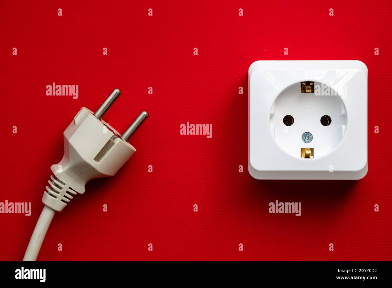 white socket and black plug isolated on red background Stock Photo