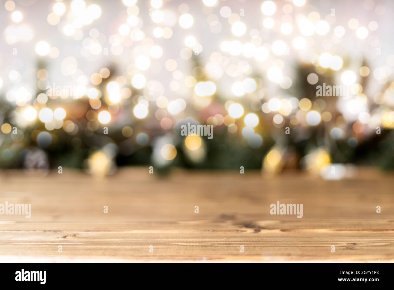 Empty rustic wooden table with blurred Christmas lights at background ...