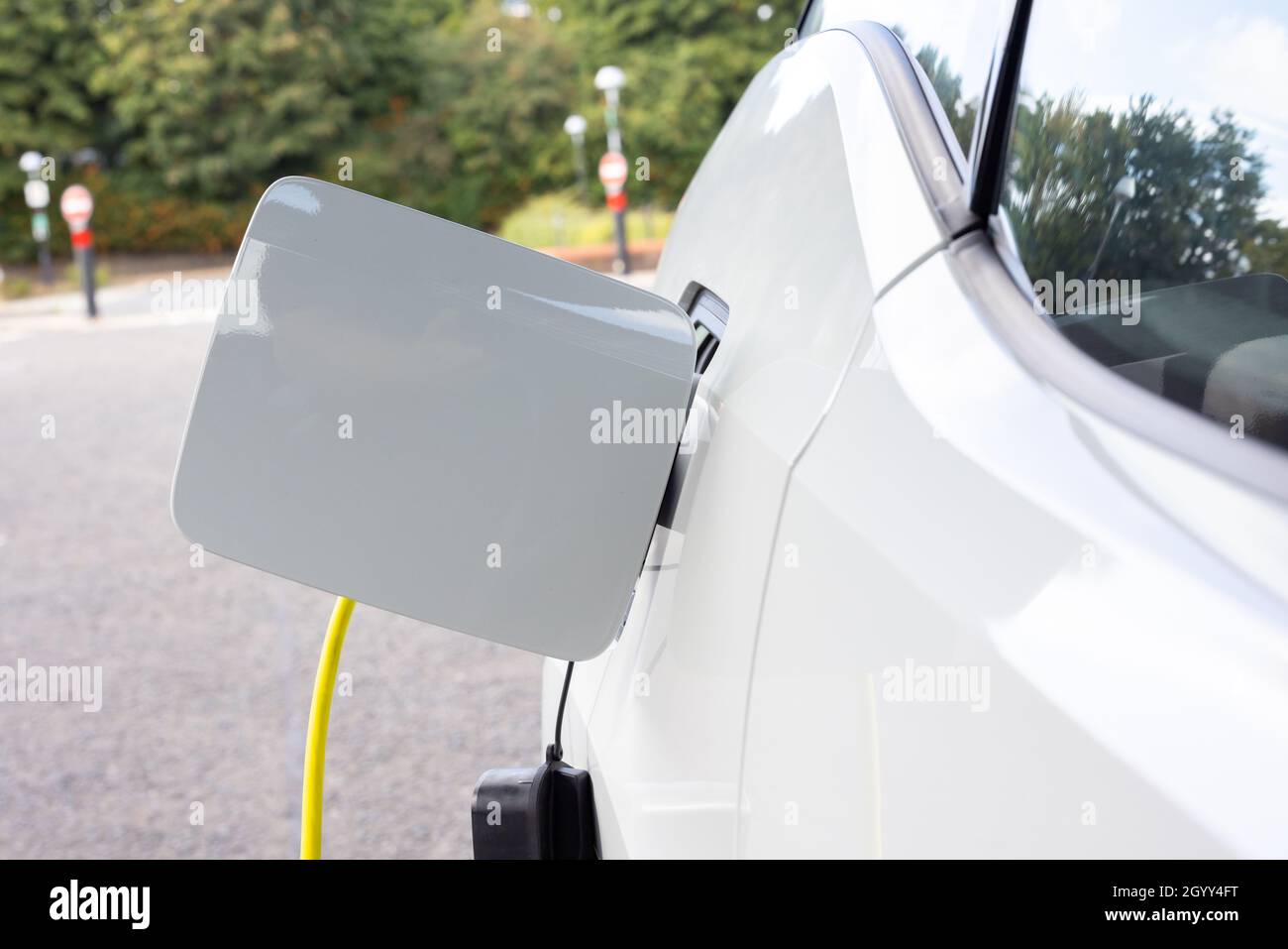 Gateshead UK: 26th Sept 2021: A hand-held closeup of an electric car on charge (EV, green sustainable travel) Stock Photo