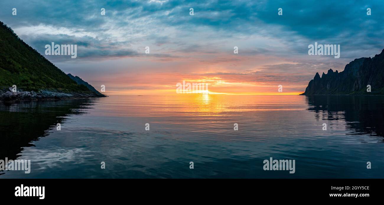 Midnight sun reflecting in the arctic sea, Ersfjord, Senja, Troms county, Norway Stock Photo