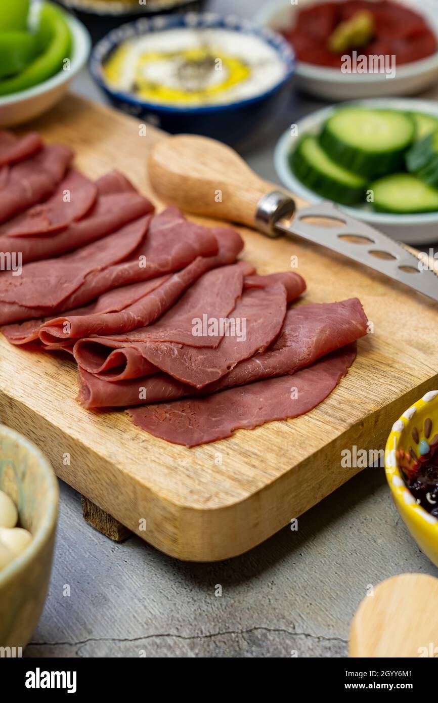 Sliced Pastrami  Romanian variant of the Turkish pastırma usually made from beef brisket. Stock Photo