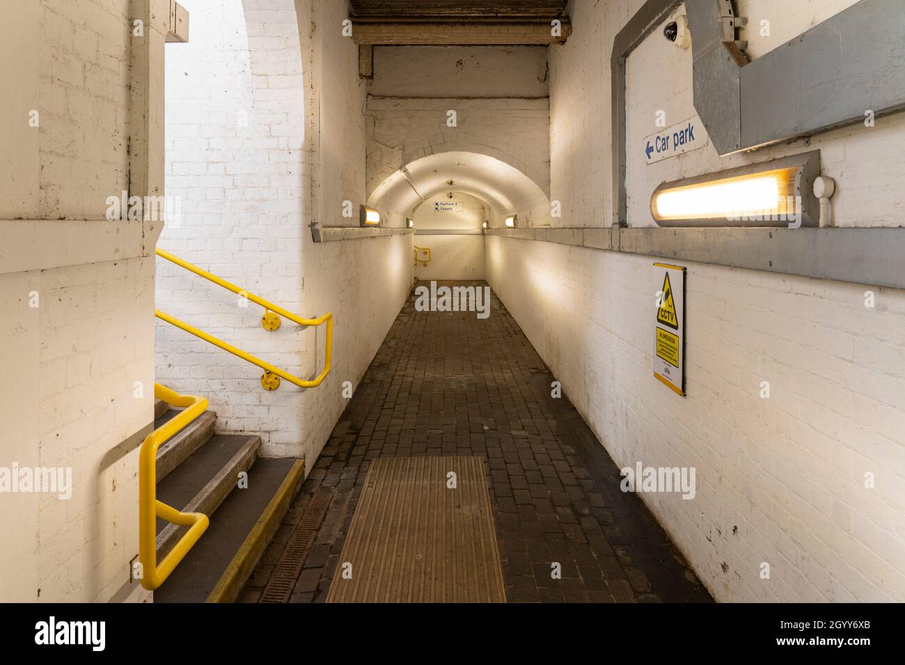 A brick lined subway / underpass underneath the railway lines providing access to platforms at Pangbourne train station in Berkshire, England Stock Photo