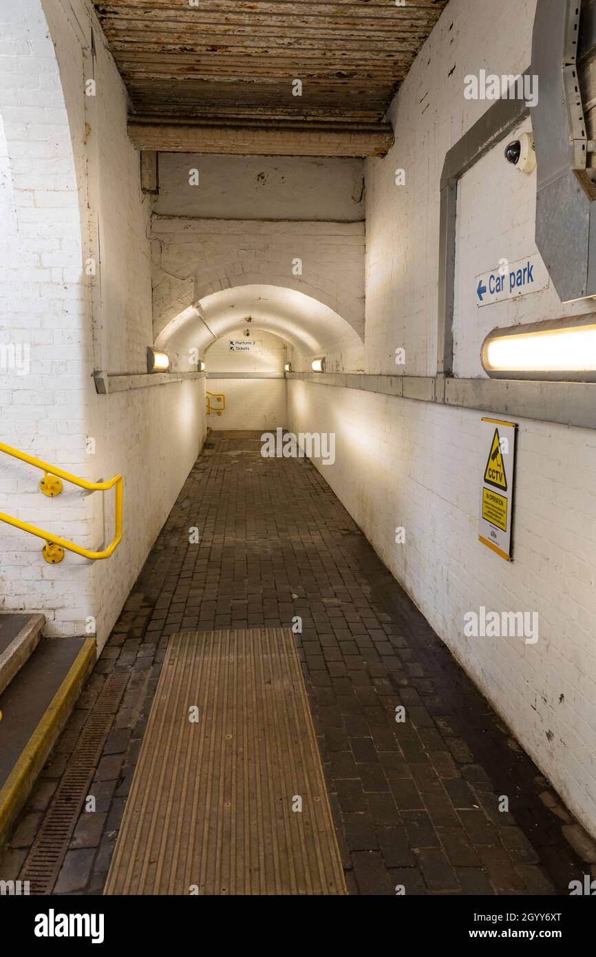 A brick lined subway / underpass underneath the railway lines providing access to platforms at Pangbourne train station in Berkshire, England Stock Photo