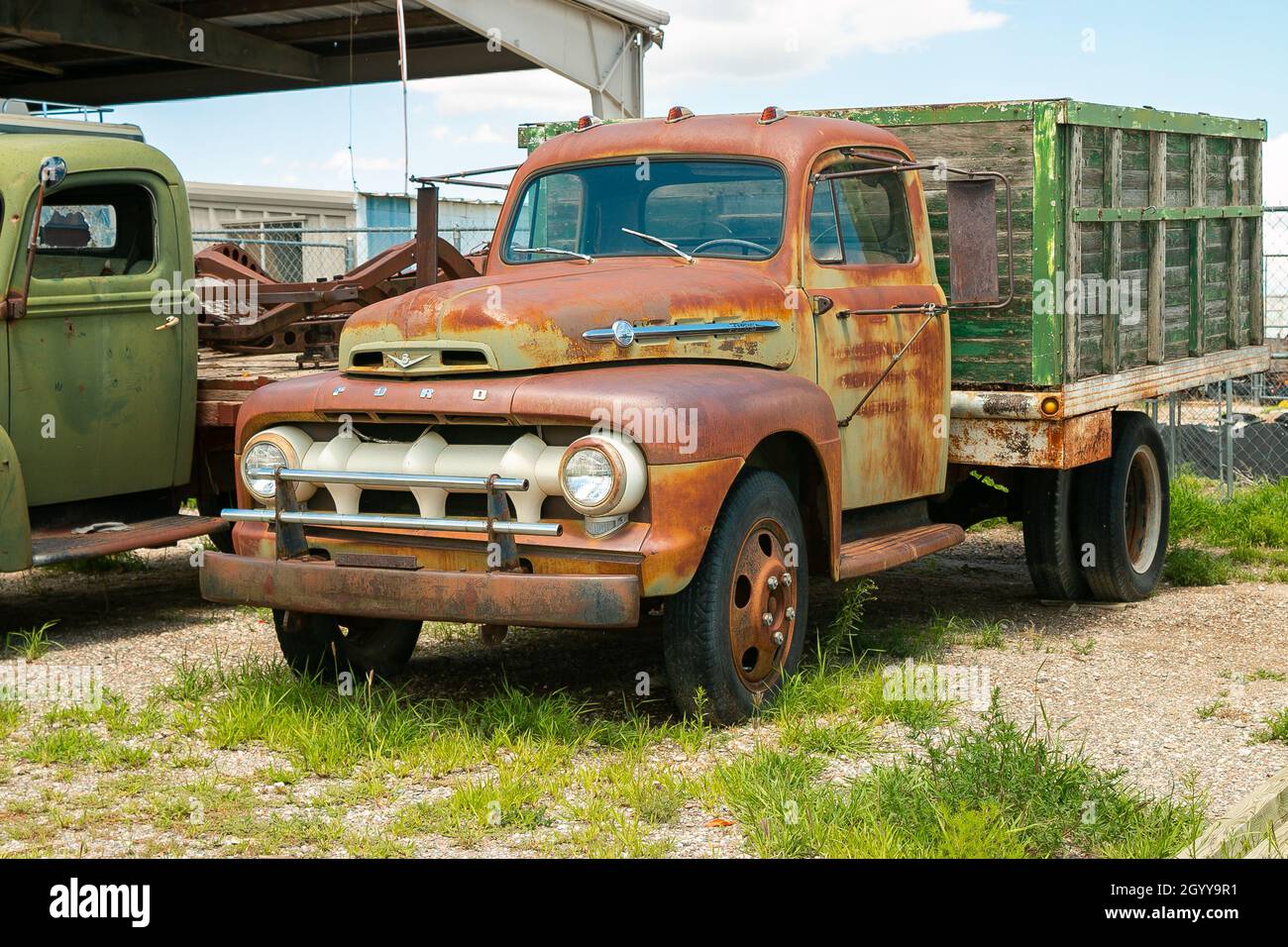 Rusty vintage pickup truck with an old wooden cargo bed parked in a ...