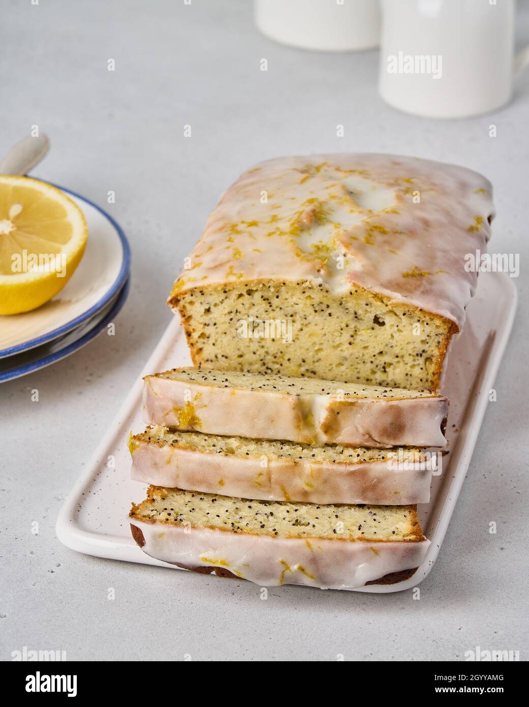 Classic sliced lemon bread with poppy seeds, white frosting and orange