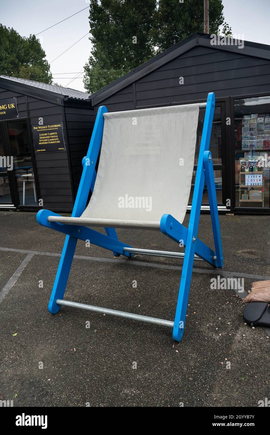 An over size fold up old style deckchair in blue and white Stock Photo ...