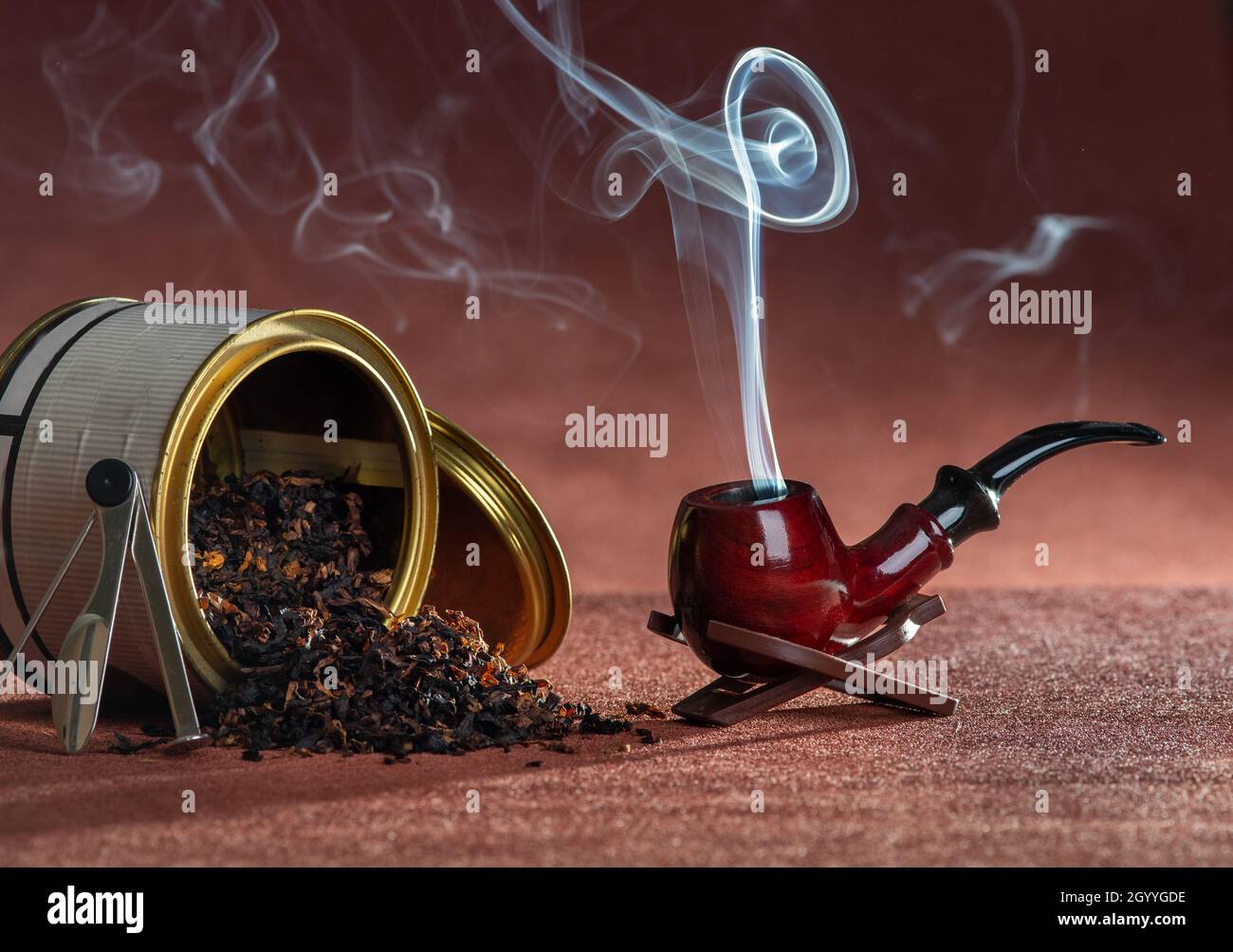 Smoking pipe and tobacco leaf on pile in sophisticated atmosphere Stock