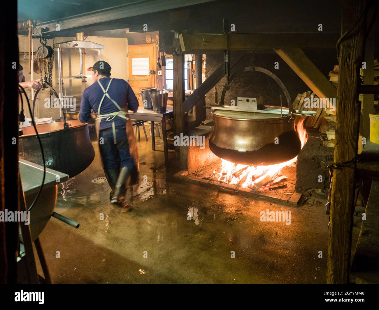 Traditional production of handmade Swiss Gruyere cheese at the alpine dairy at Moleson, Gruyere. Stock Photo