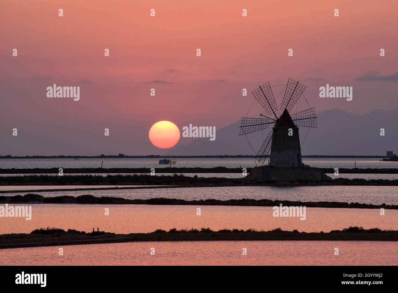 Magical Sunset over the Windmill at the Sicilian Saltworks Stock Photo