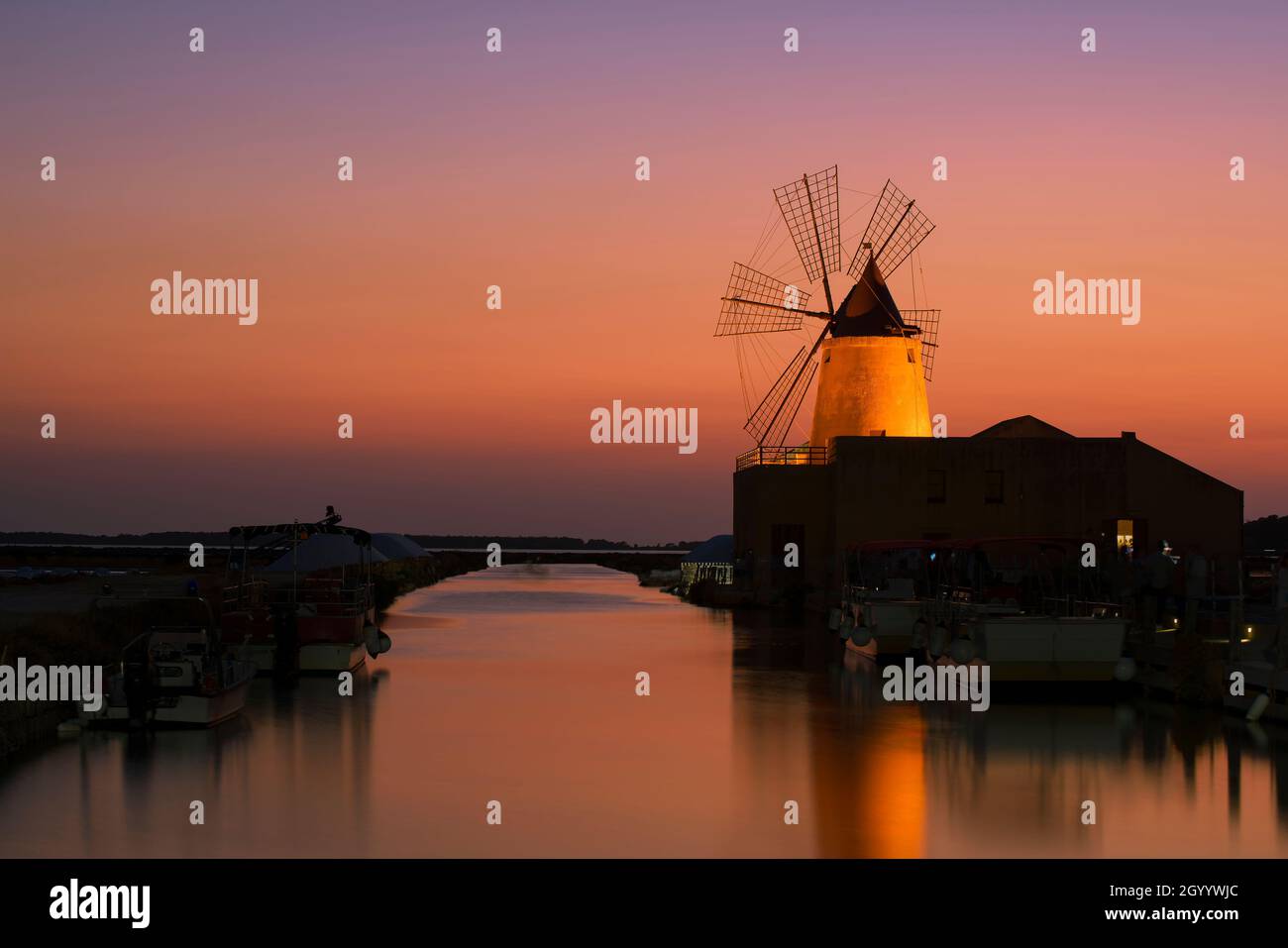 Magical Twilight on the Windmill at the Sicilian Saltworks Stock Photo