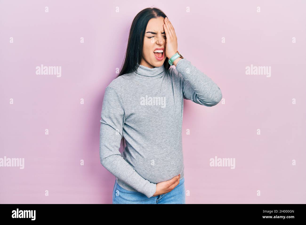 Beautiful woman with blue eyes expecting a baby, touching pregnant