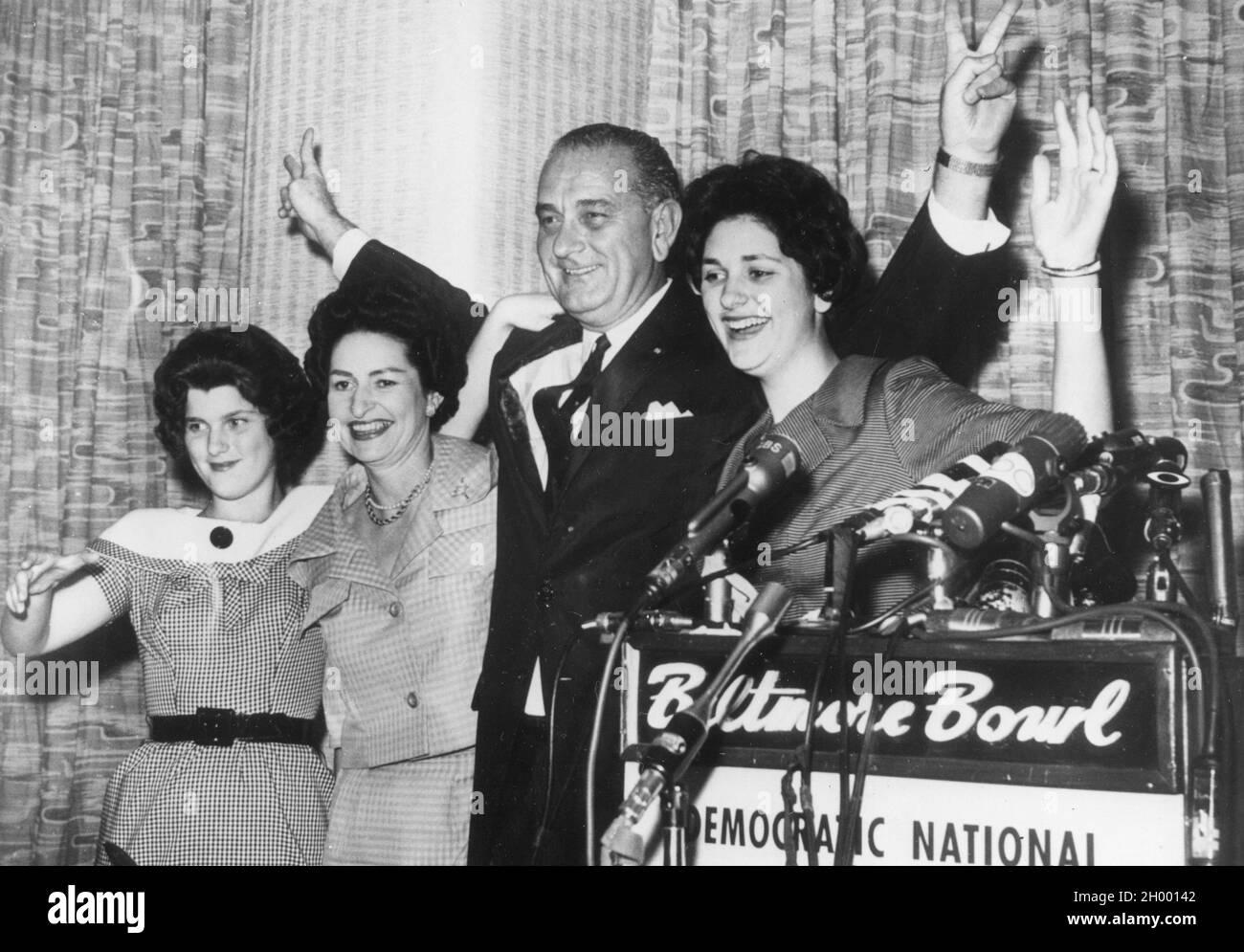 Senator Lyndon B. Johnson introduces his teen-aged daughters and wife to the audience at a press conference after his nomination to run as Vice-President on the Democratic ticket. Left to right: Lucy Baines, 13; Mrs. Johnson; and Lynda Byrd, 16. Los Angeles, July 8, 1960. Stock Photo