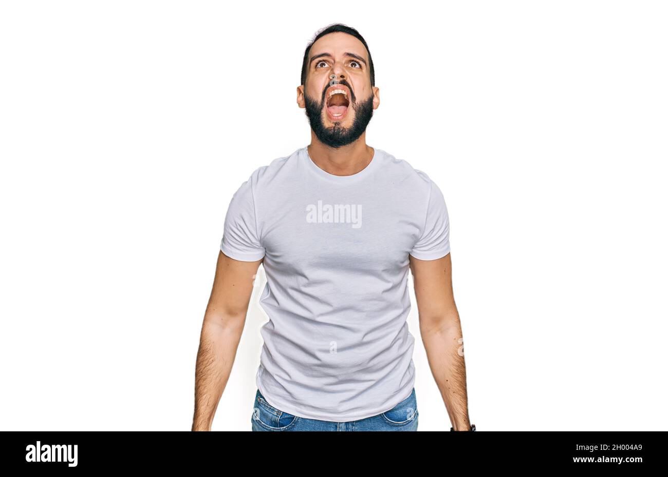 Young man with beard wearing casual white t shirt angry and mad ...