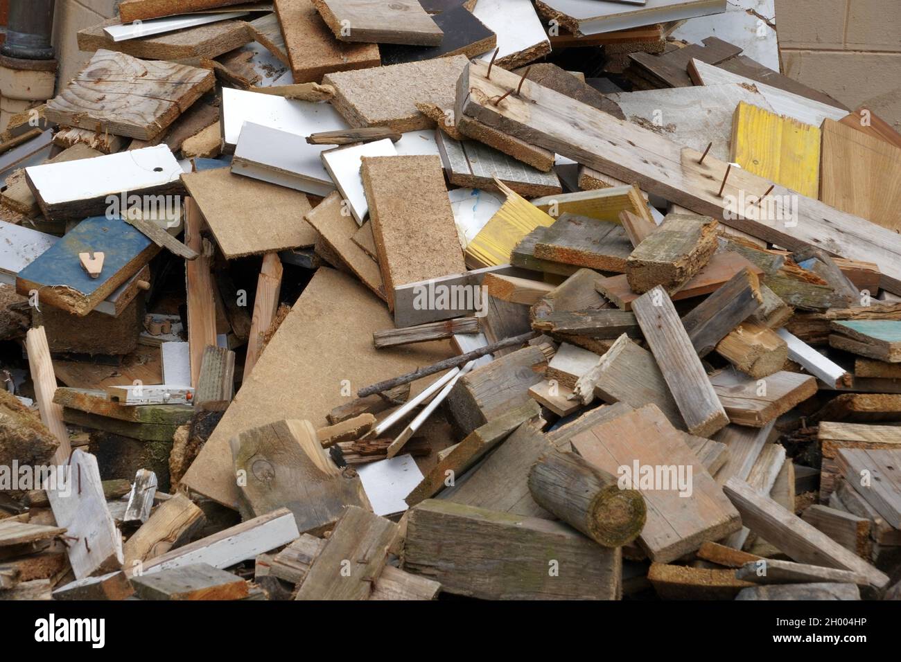 Dismantled furniture cut into pieces. There are pieces of wood. They are of irregular size. It looks like vacating of a dwelling. Detail view. Stock Photo