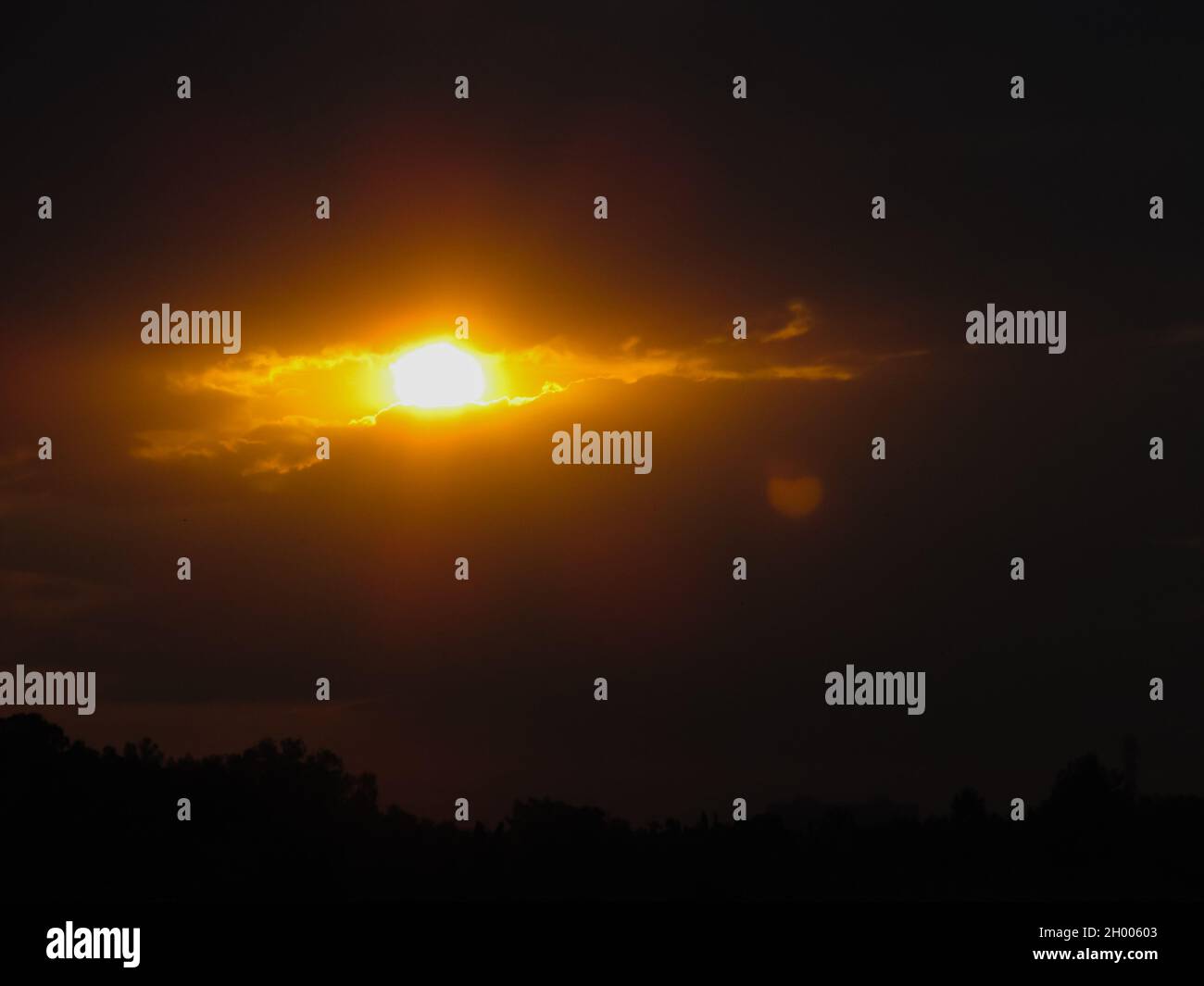 the shape of the sun and clouds looks like a burning eye in the sky Stock Photo Alamy
