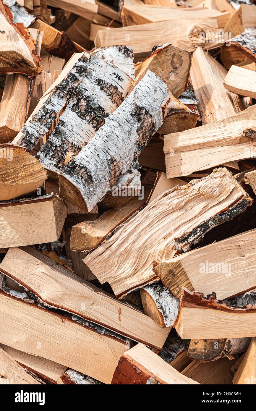 Preparation of firewood for the winter. Stacks of firewood in the