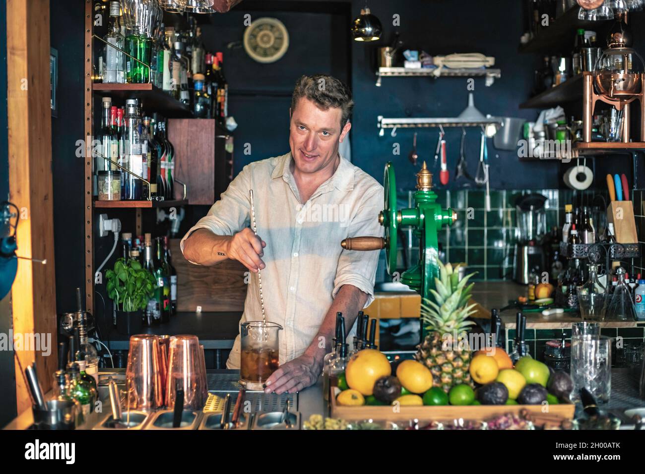Expert barman is making cocktail with shaker at night club. Copy space  Stock Photo - Alamy