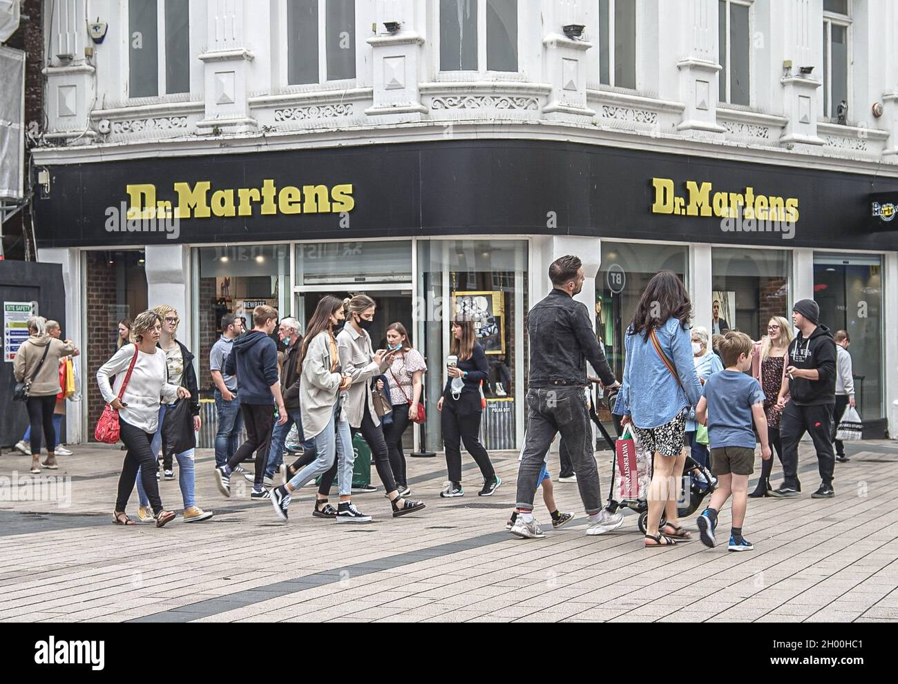 Shoppers walk past Dr. Martens Fashion Footwear Retail Store in Corn Market  in Belfast Stock Photo - Alamy