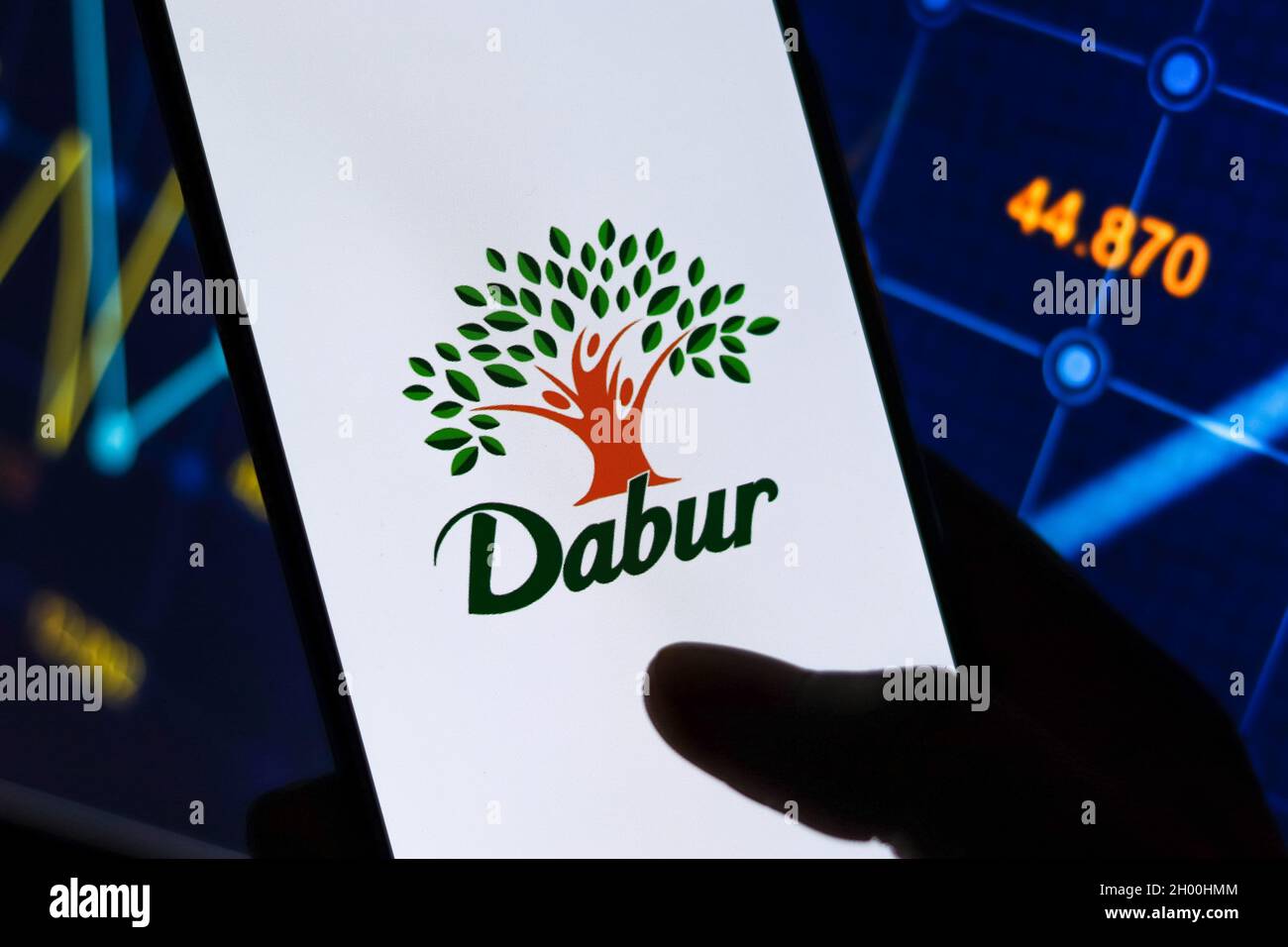 West Bangal, India - October 09, 2021 : Dabur logo on phone screen stock image. Stock Photo