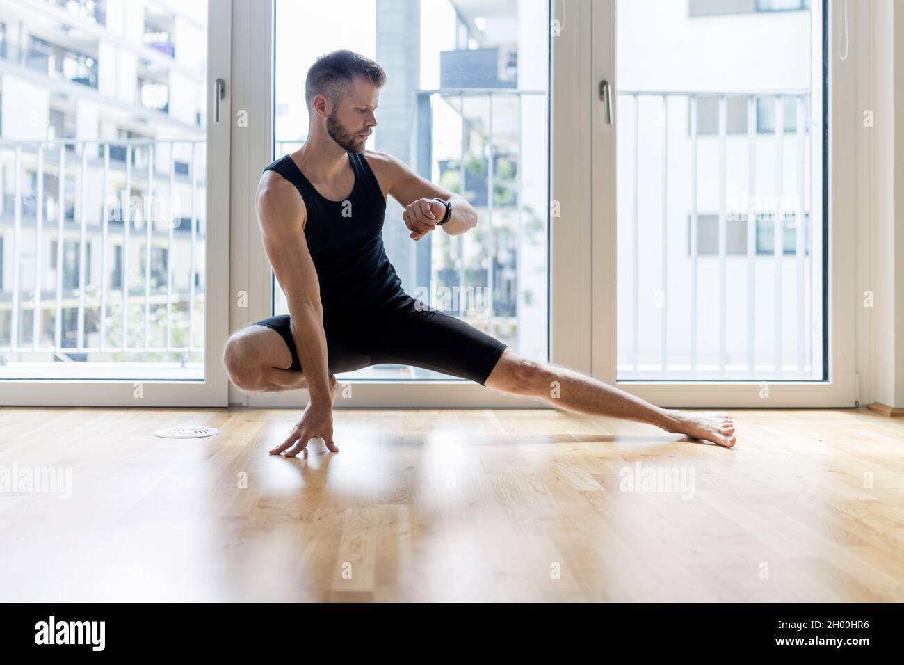 Young handsome man practicing yoga at home Stock Photo