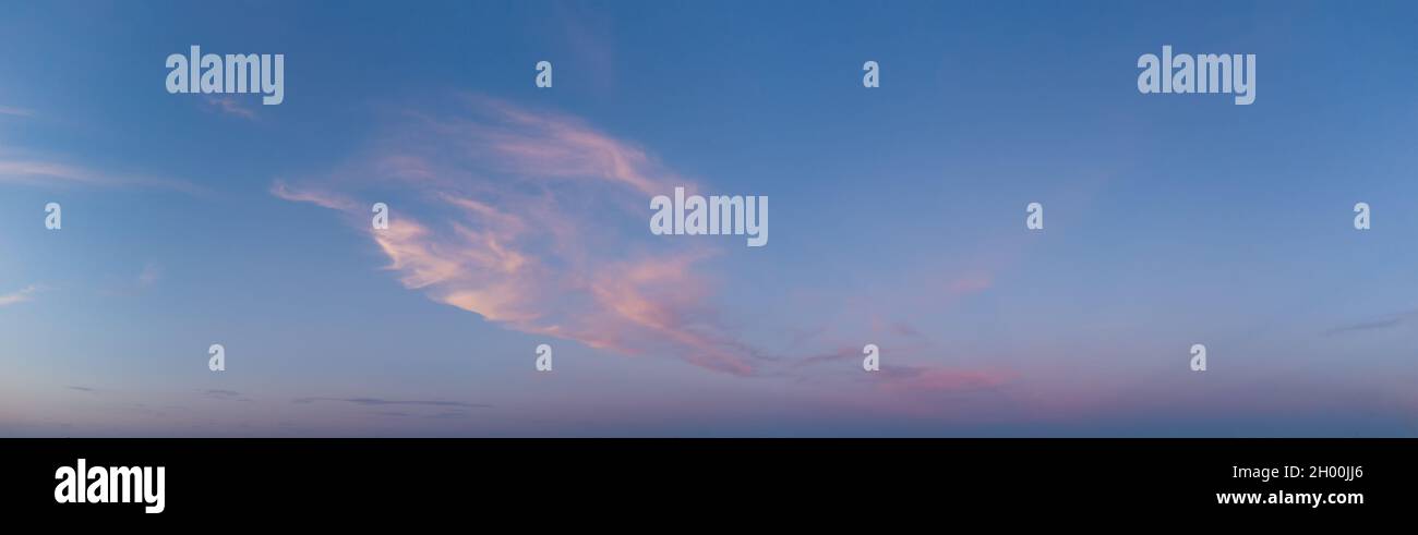 Panorama of blurred clouds in the blue sky in the evening. Stock Photo