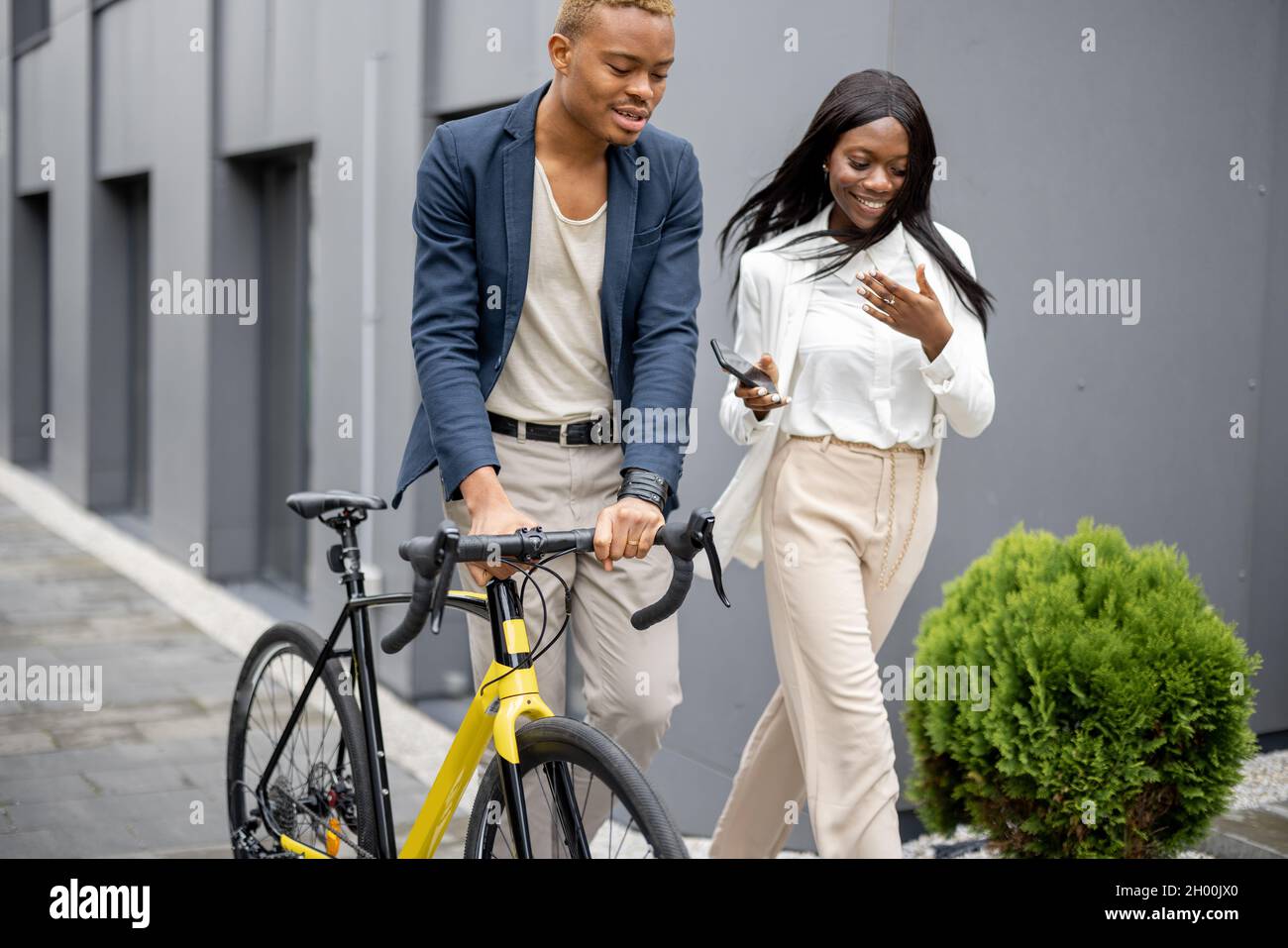 Business people walking on city street and talking Stock Photo - Alamy