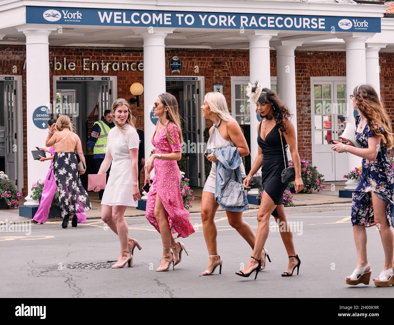 Racegoers all dressed up for a day's horse racing on a summer weekend event at York Racecourse York, North Yorkshire, England UK 2021 Stock Photo