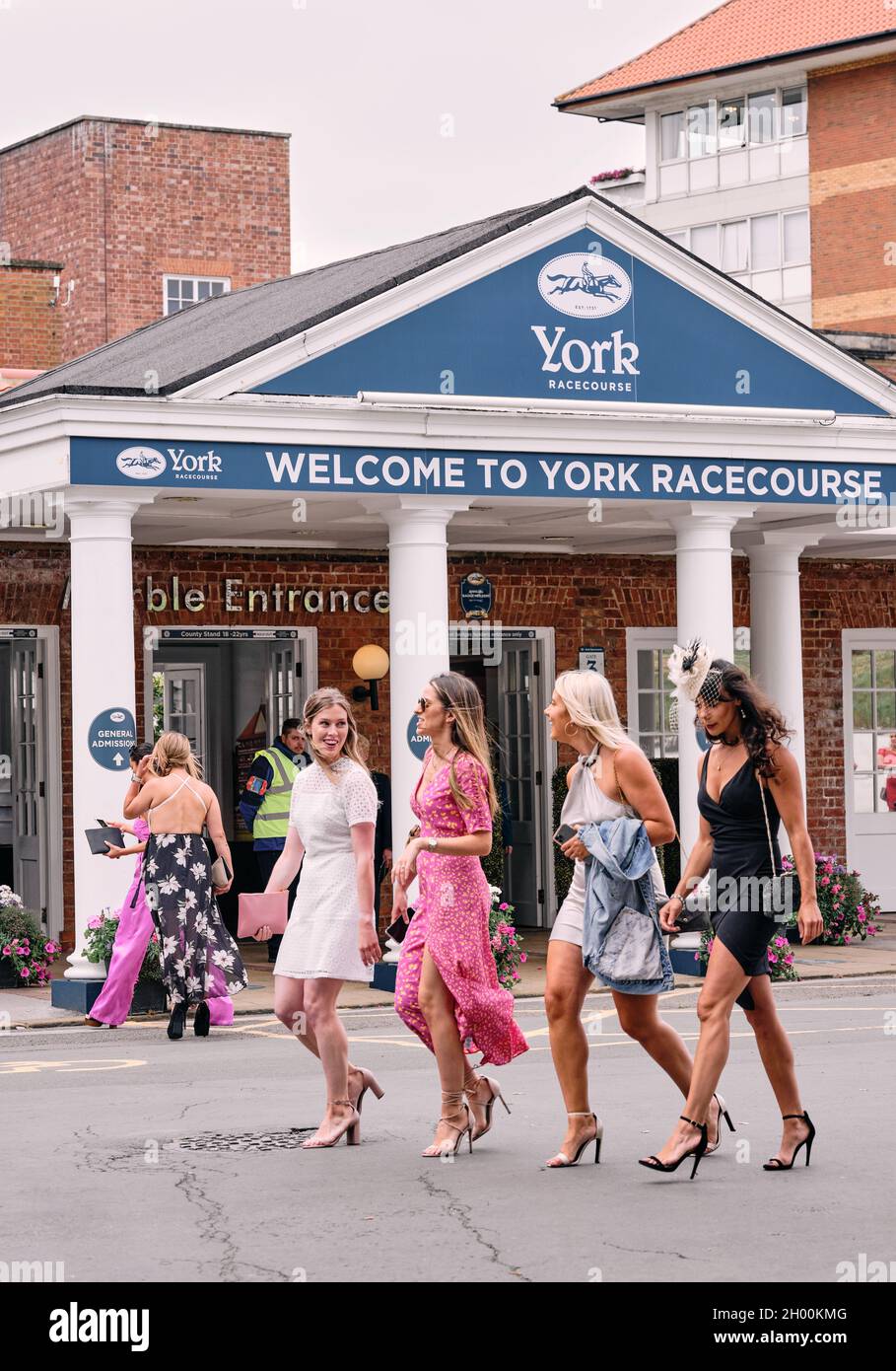 A day at the races - Racegoers all dressed up for a day's horse racing on a summer weekend event at York Racecourse York,Yorkshire, England UK 2021 Stock Photo