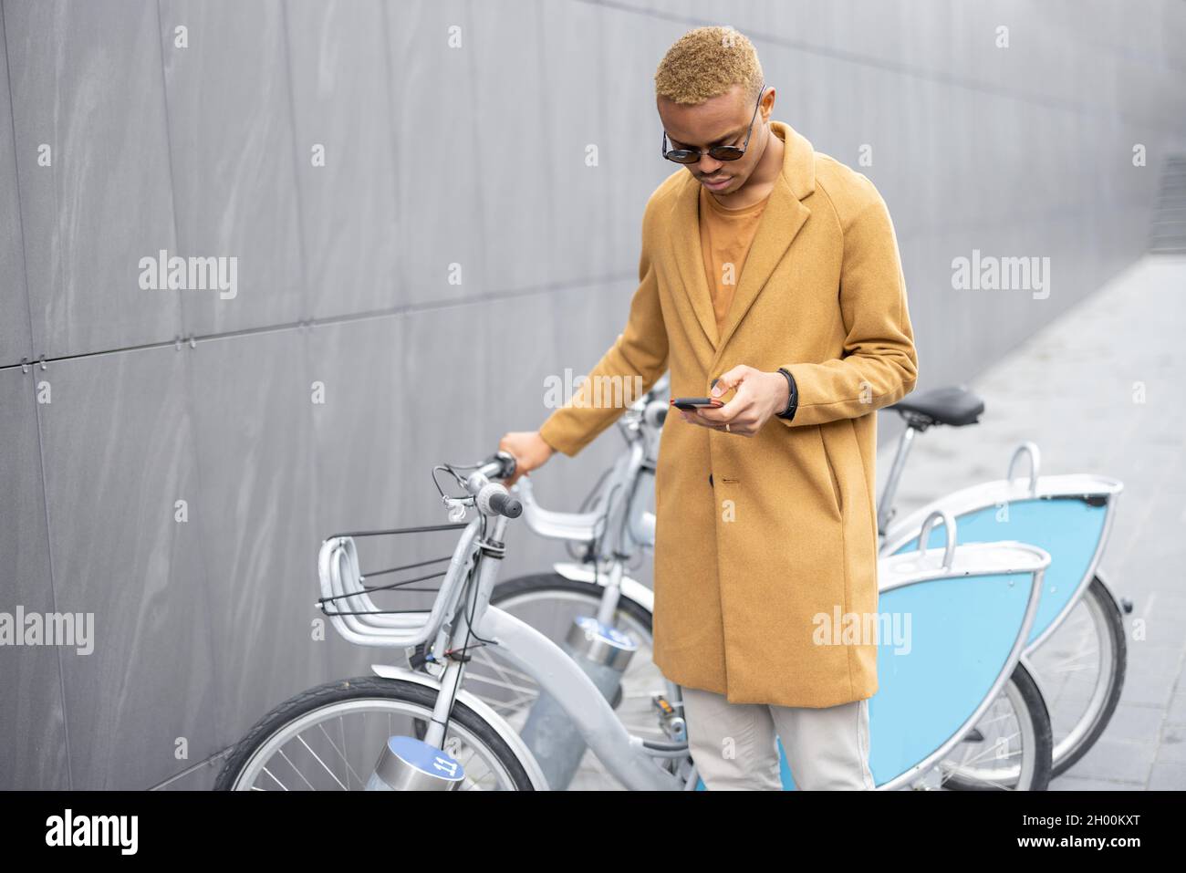 Man using smartphone app for bike rent Stock Photo