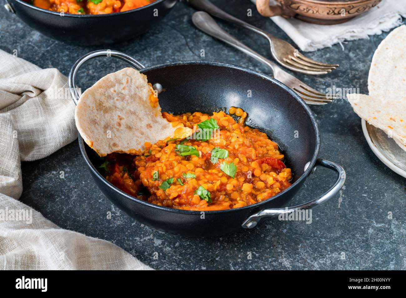 Indian vegetarian red lentil dhal curry with roti Stock Photo - Alamy