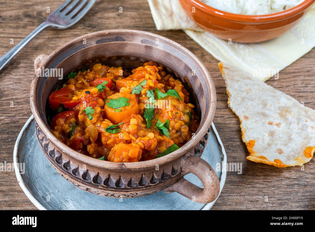 Indian vegetarian red lentil dhal curry with roti and rice Stock Photo ...