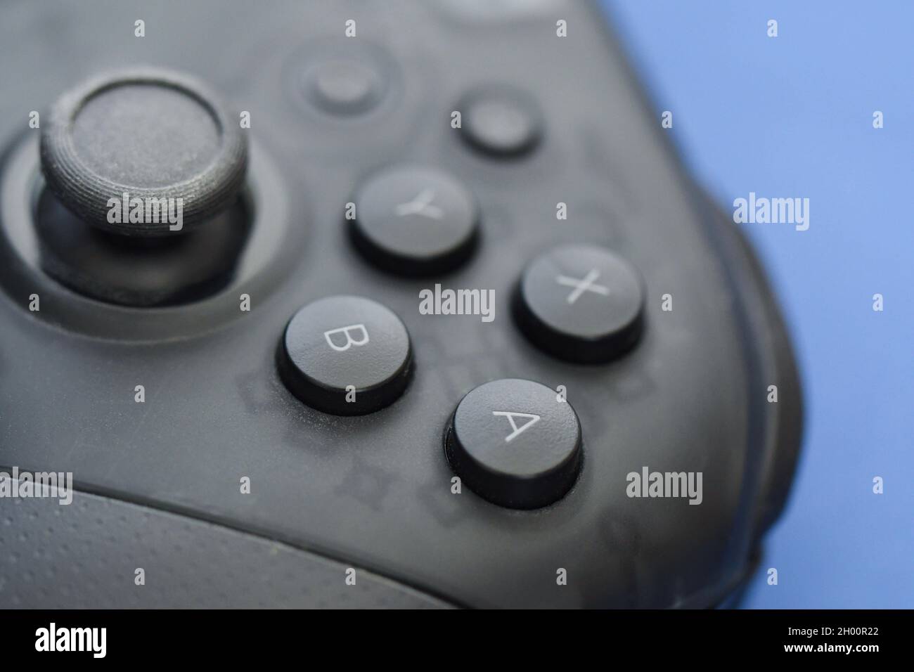 Photo of a gaming controller on blue background Stock Photo