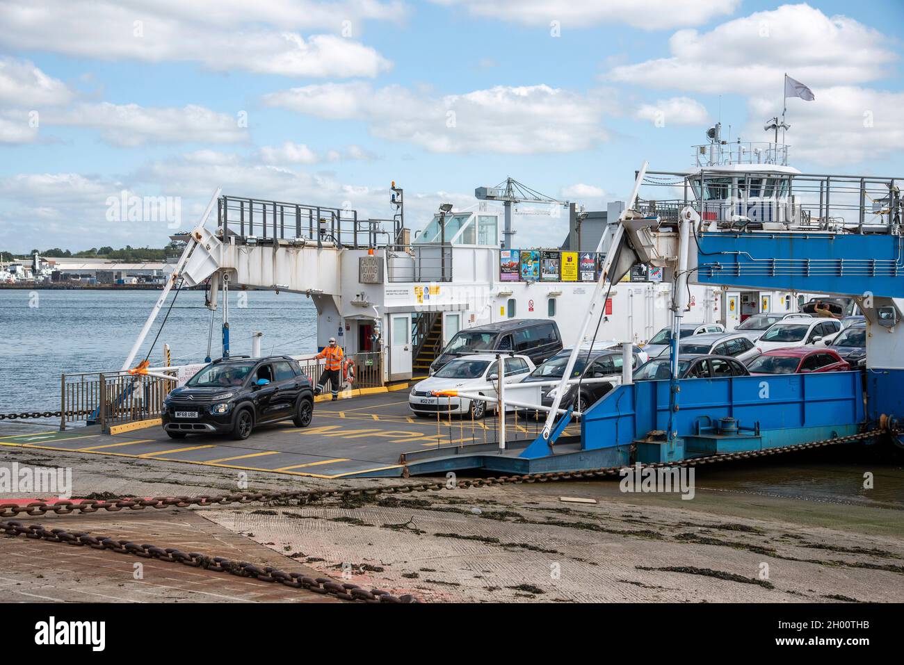Torpoint, Cornwall, England, UK. 2021. Vehicles loading and unloading from a roll on rool off chain ferry which crosses the River Tamar between Plymou Stock Photo