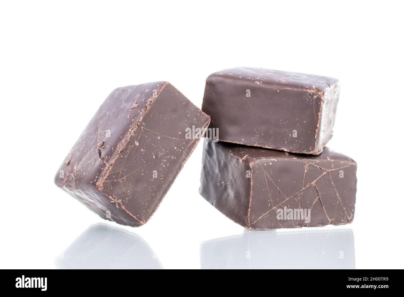 Three sweet chocolate candies, close-up, isolated on white. Stock Photo