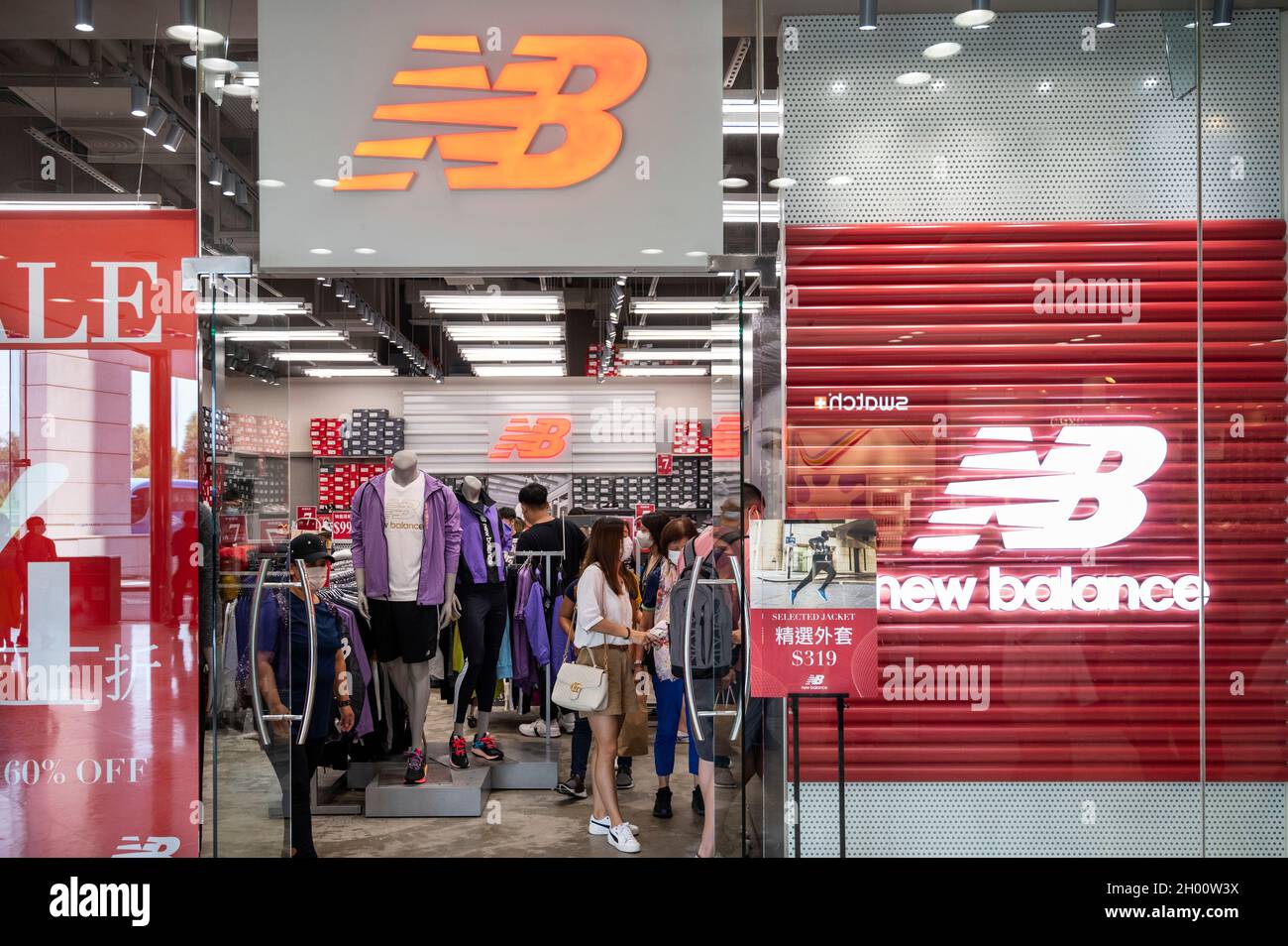 Hong Kong, China. 07th Oct, 2021. Shoppers are seen at the American  footwear brand New Balance (NB) and German multinational athletic and  casual footwear brand Puma stores and logo in Hong Kong.