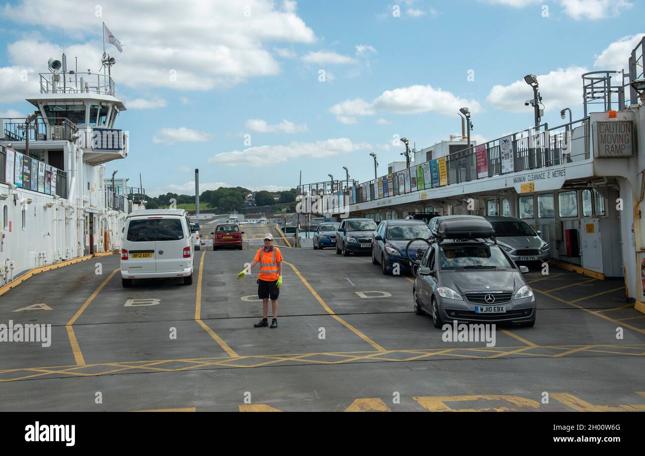 Torpoint, Cornwall, England, UK. 2021. Vehicles loading and unloading from a roll on rool off chain ferry which crosses the River Tamar between Plymou Stock Photo